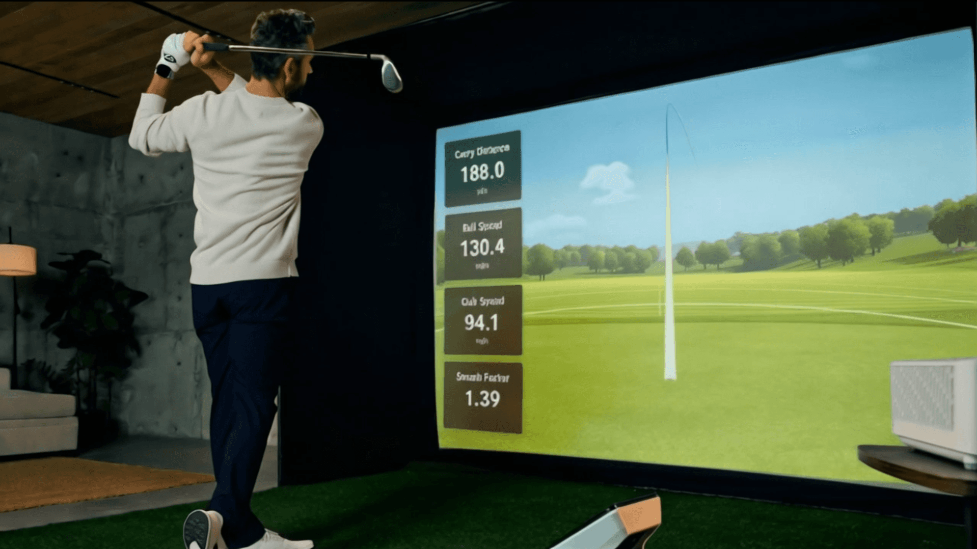 Golf Studio simulator in use showing projected course with swing metrics