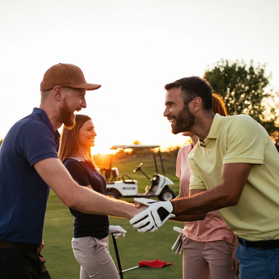 Friends enjoying a round of golf at Welbeck Manor at sunset
